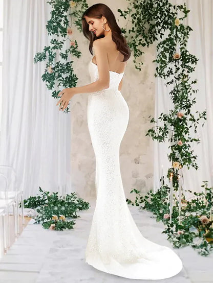 Close-up of the intricate sequin embellishments on the one-shoulder satin wedding dress.