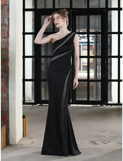 Side profile of a woman in an elegant mermaid evening dress.