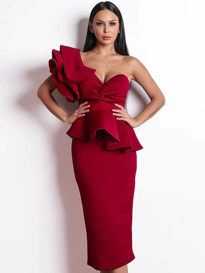 Woman wearing an elegant one-shoulder ruffled tea-length cocktail dress.