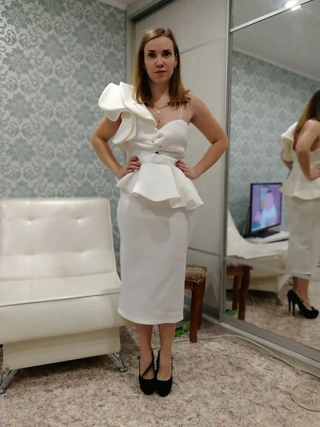 Back view of a woman in a one-shoulder spandex cocktail dress with ruffles.