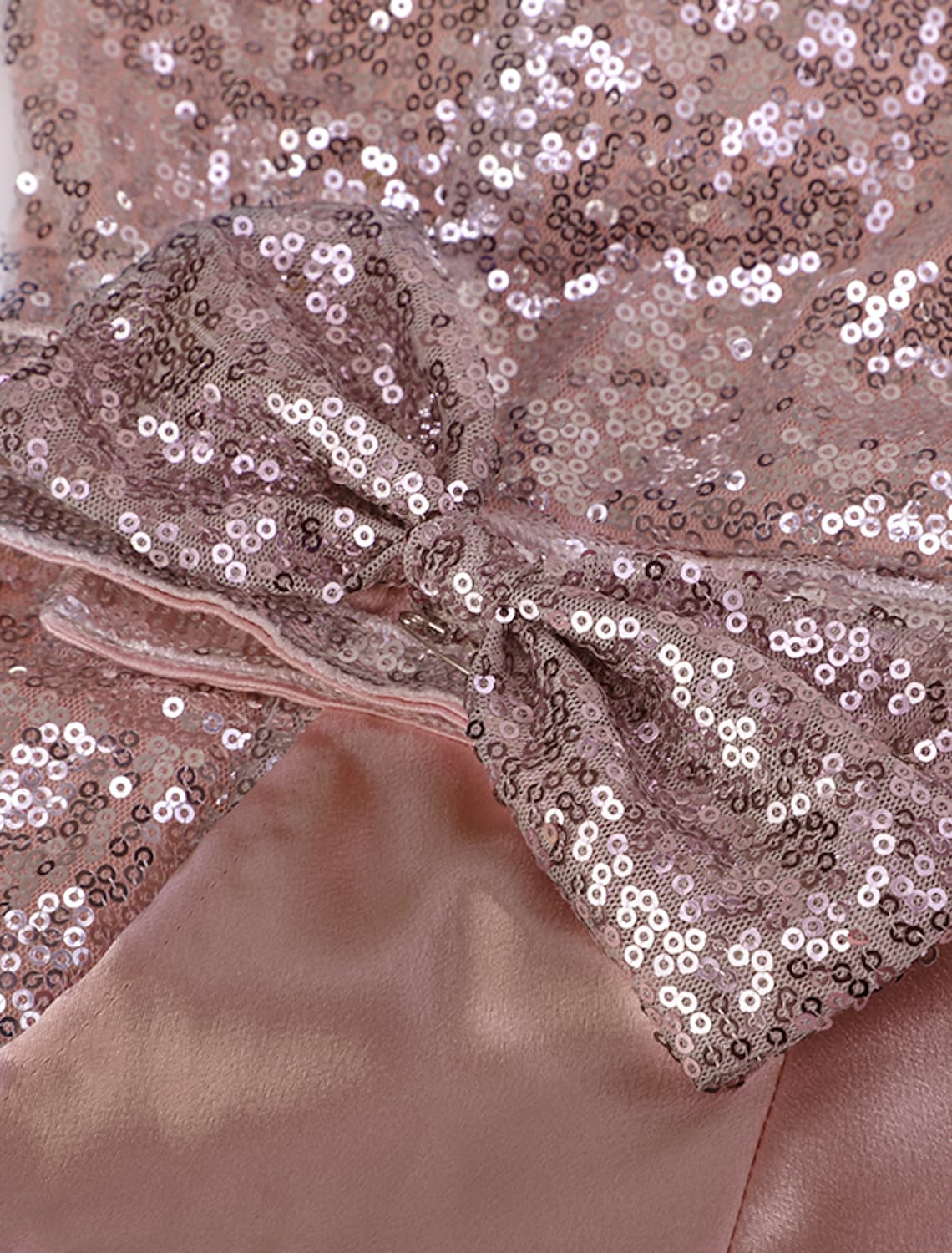 Woman in a stunning pink one-shoulder sequin party dress.