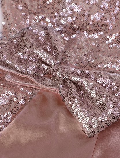 Woman in a stunning pink one-shoulder sequin party dress.