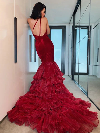 Red one-shoulder sleeveless gown, showcasing organza layers and flowing silhouette.
