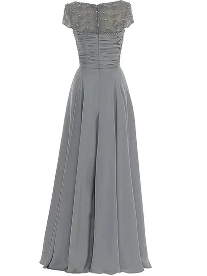 Close-up of the elegant chiffon Mother of the Bride dress, highlighting the jewel neck, beading, and pleats.
