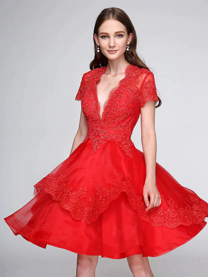 Back view of the knee-length ball gown, highlighting the elegant silhouette and button embellishments.