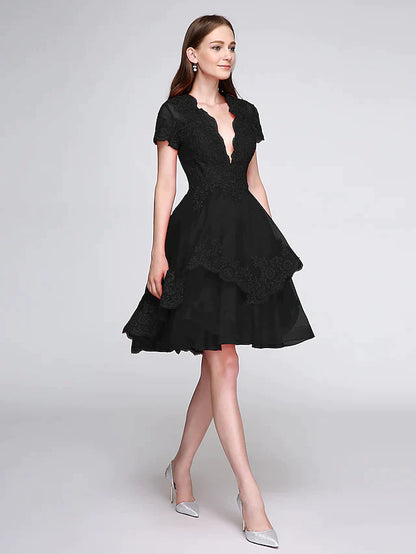 Detailed shot of the plunging neckline and delicate lace appliques on the front of the elegant dress.