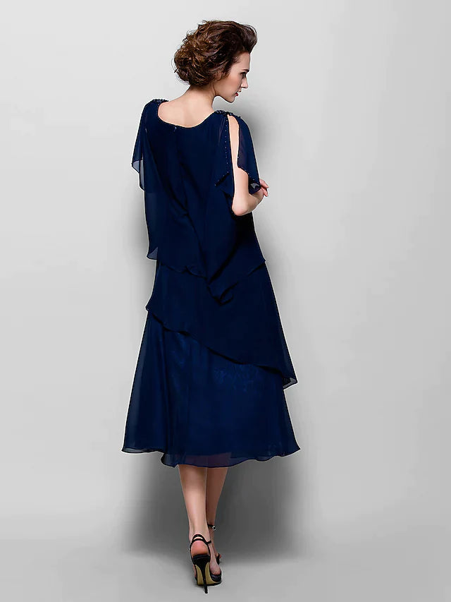 Close-up of the cowl neck and ruffled short sleeve detail on the elegant chiffon dress.