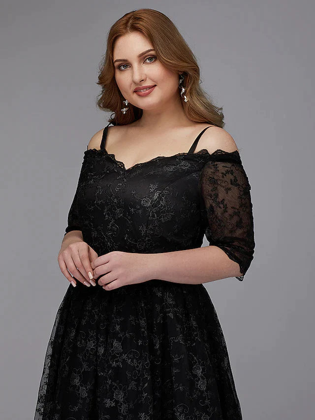 Back view of the elegant navy blue spaghetti strap dress, showcasing its silhouette.