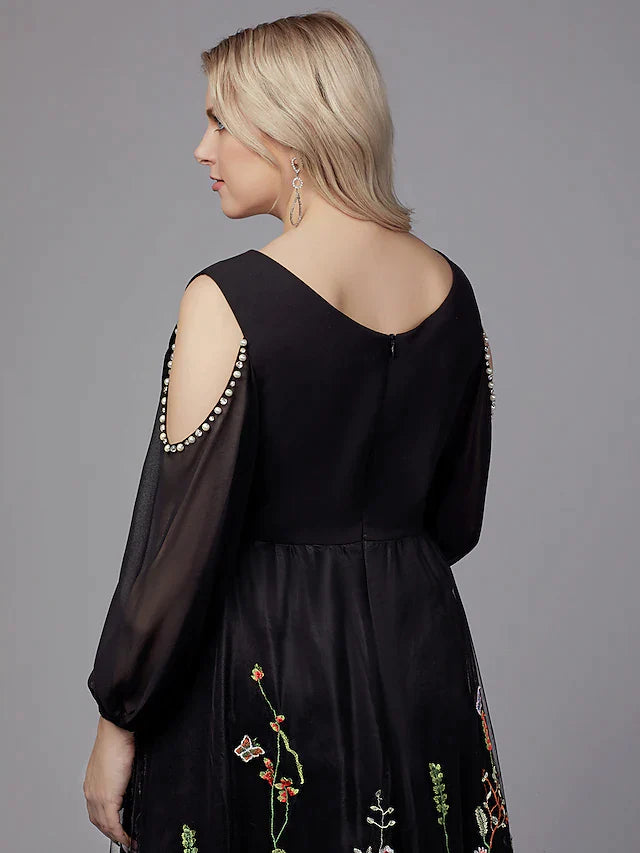 Model showcasing the 3/4 sleeve tulle cocktail dress.