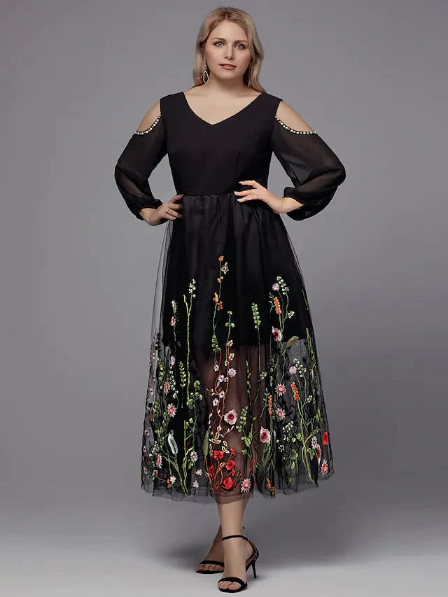 Elegant plus size model wearing a dark A-line V-neck tea-length dress with delicate beading and 3/4 sleeves.