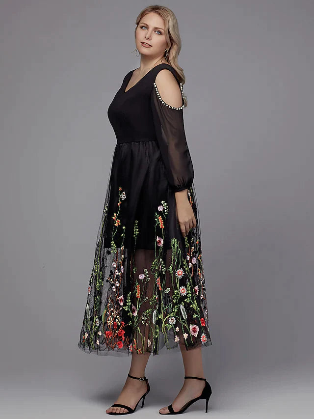 Close-up of the dark A-line V-neck dress, highlighting the intricate beading appliques on the bodice and sleeves.