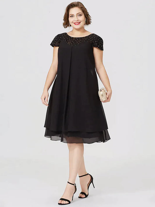 Plus size woman wearing a black chiffon lace Mother of the Bride dress, front view.