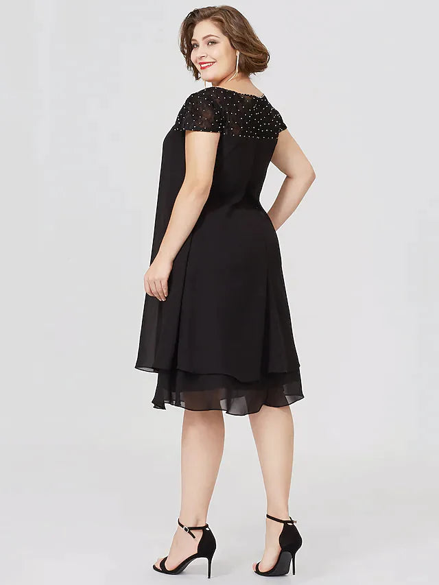 Back view of the black plus size Mother of the Bride dress with short sleeves.