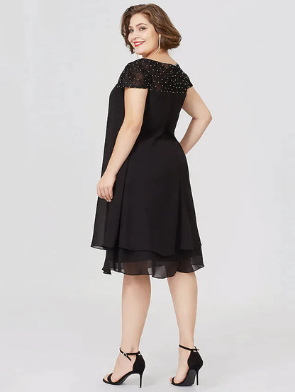 Back view of the black plus size Mother of the Bride dress with short sleeves.