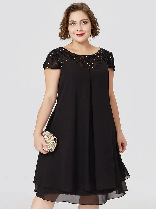 Side profile of the elegant black plus size dress, showing pleats and knee length.