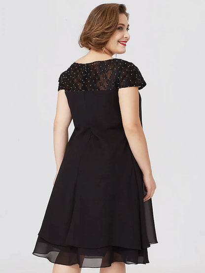 Close-up of the jewel neck and lace short sleeves on the black dress.