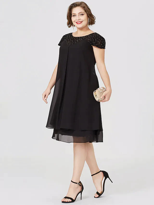 Detail of the lace insert and beading on the black chiffon dress.