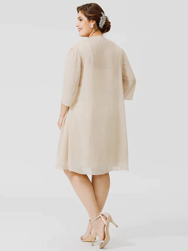 Elegant plus size knee-length dress with criss-cross back straps.