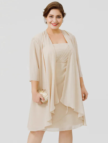 Woman modeling a navy plus size formal dress with sheer lace details.