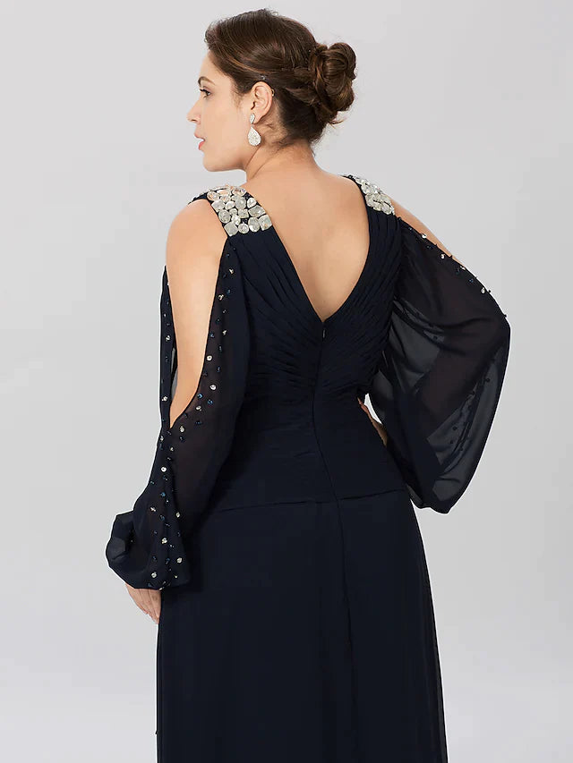 Close-up of the V-neckline and criss-cross crystal embellishments on the dress.
