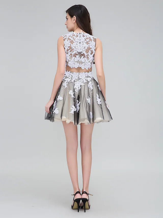 Back view of a plus size two-piece dress, showing the lace detailing and short tulle skirt.