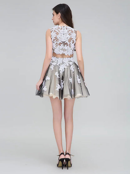 Back view of a plus size two-piece dress, showing the lace detailing and short tulle skirt.