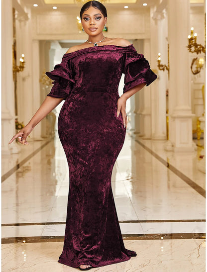 Plus size velvet mermaid gown with off-shoulder neckline and ruffles.