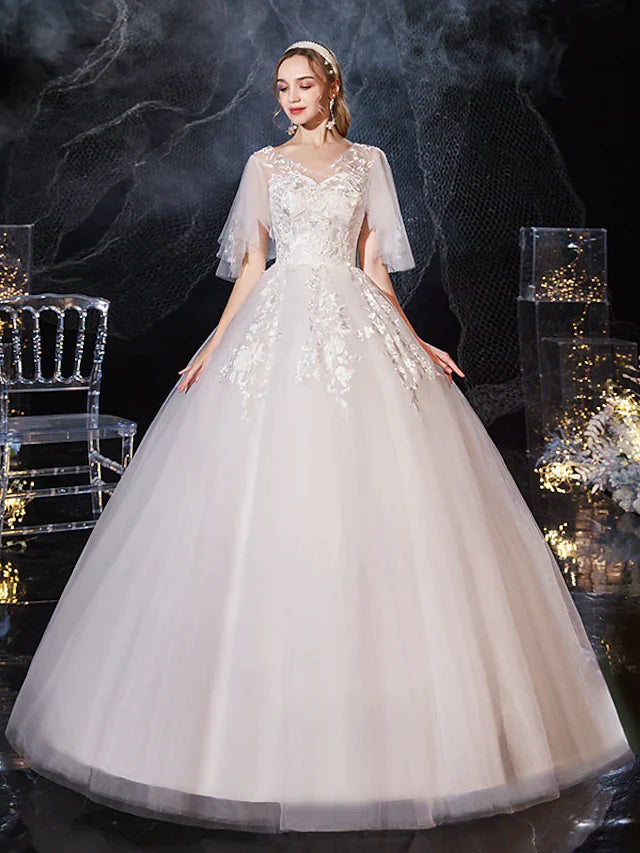 Bride wearing a V-neck half-sleeve lace tulle princess ball gown wedding dress with appliques.