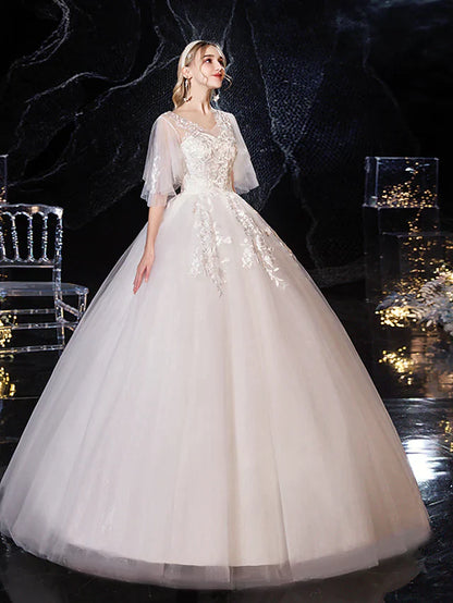 Full length view of a bride posing in a princess ball gown wedding dress.