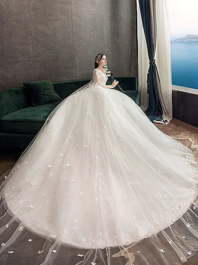 Back view of a Princess Ball Gown Wedding Dress showing the chapel train and appliques.