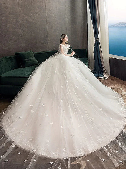 Back view of a Princess Ball Gown Wedding Dress showing the chapel train and appliques.