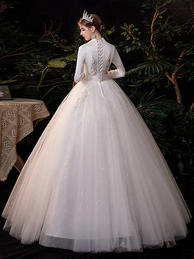 Side view of the princess ball gown wedding dress, highlighting the tulle skirt and appliques.
