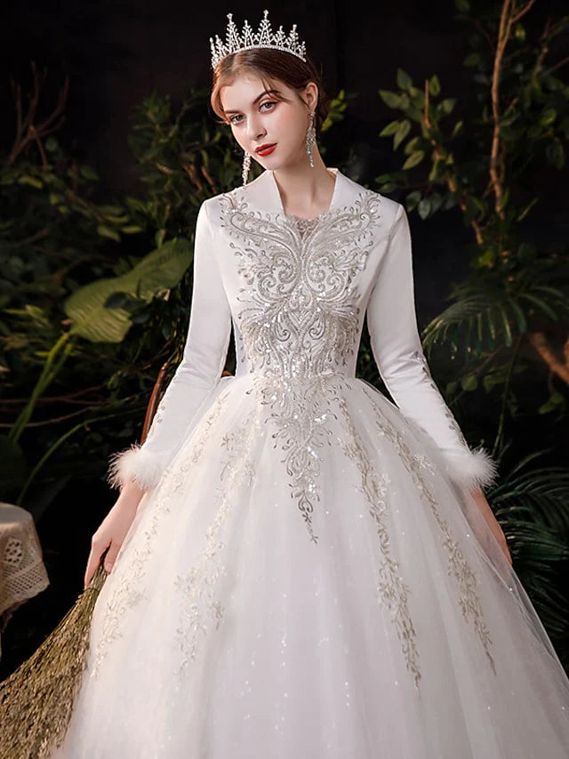 Full length view of the sparkling tulle skirt and delicate appliques on the princess wedding gown.