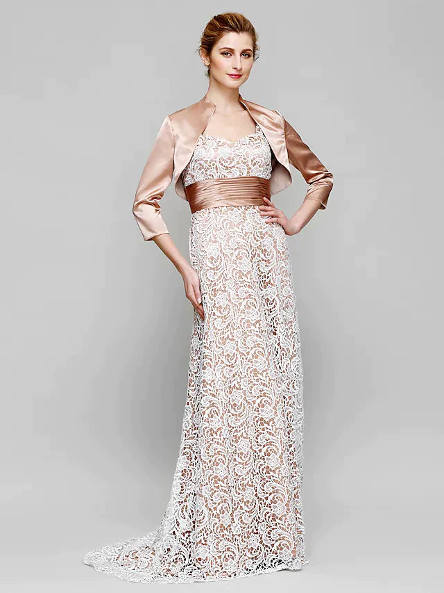 Model wearing a long, light-colored Mother of the Bride dress with convertible straps and ruched lace details.
