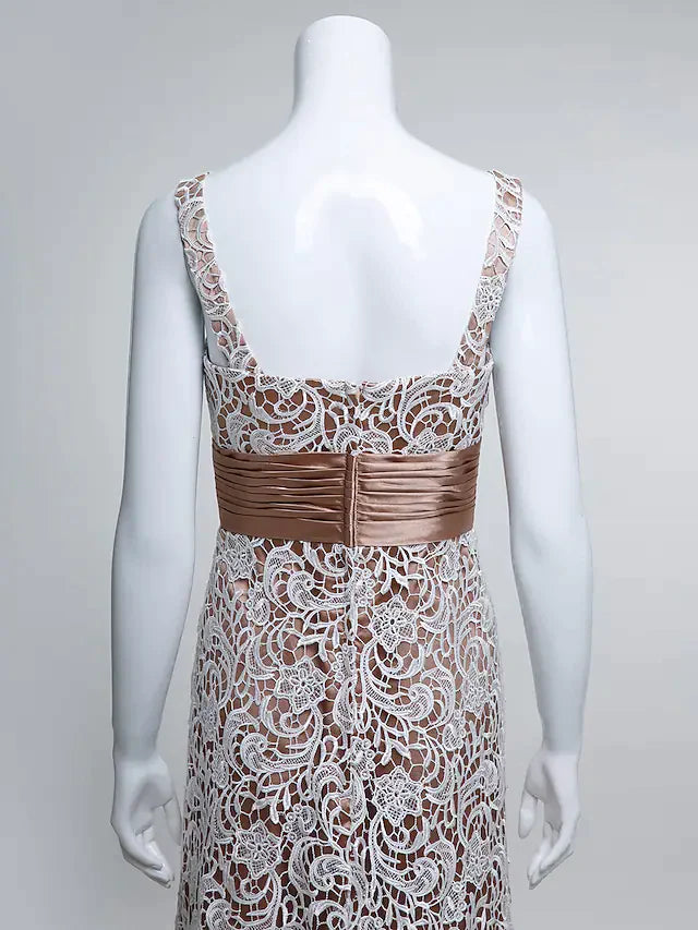 Close-up of the delicate lace and ruched detailing on the bodice of the formal dress.