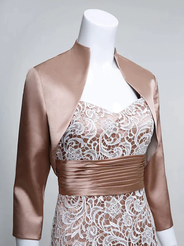 Model seated, displaying the graceful drape of the long charmeuse Mother of the Bride dress.
