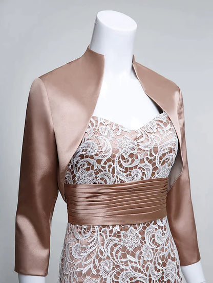 Model seated, displaying the graceful drape of the long charmeuse Mother of the Bride dress.