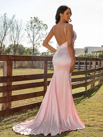 Side view of the pink silk-like satin prom dress, highlighting ruched details.