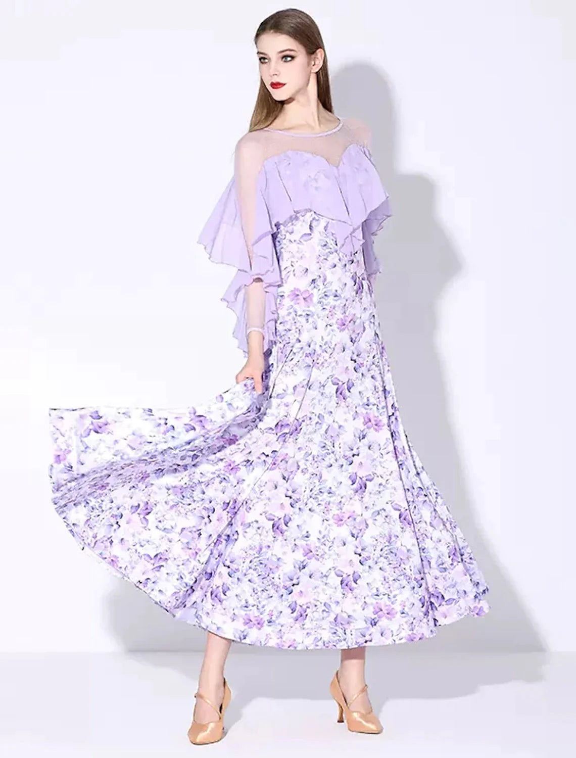 Woman posing in an elegant long sleeve ruffled printed ballroom dance dress.