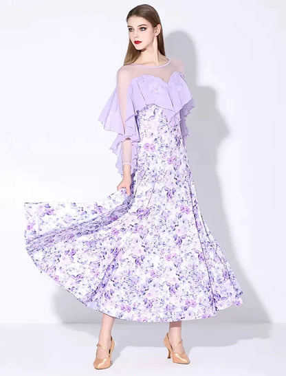 Woman posing in an elegant long sleeve ruffled printed ballroom dance dress.