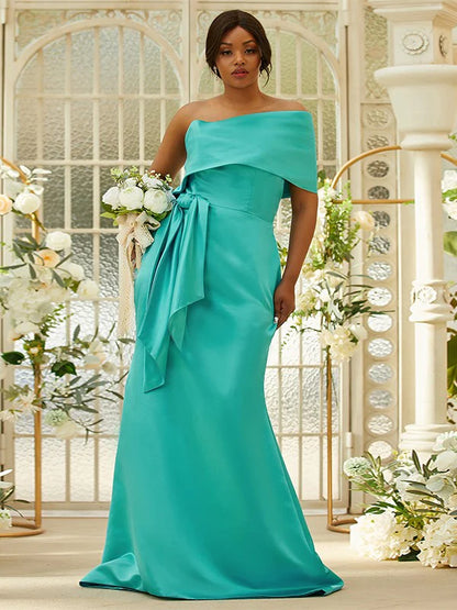 Front view of a woman wearing an elegant green satin ruched one-shoulder long bridesmaid dress.