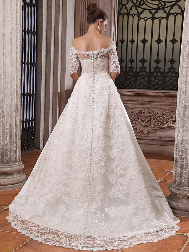 Back view of the ball gown wedding dress, showing the court train and satin fabric.