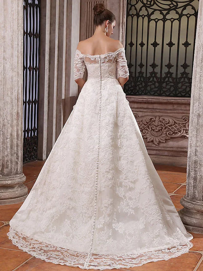 Back view of the ball gown wedding dress, showing the court train and satin fabric.