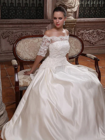 Side view of the bride in the elegant satin ball gown, highlighting the silhouette.