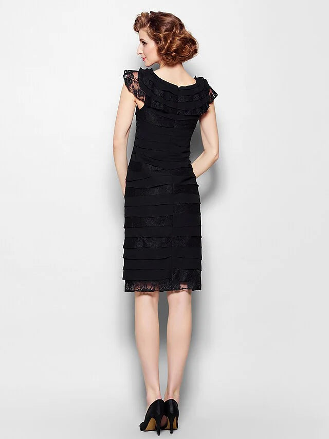Side view of a woman in an elegant black chiffon lace dress.