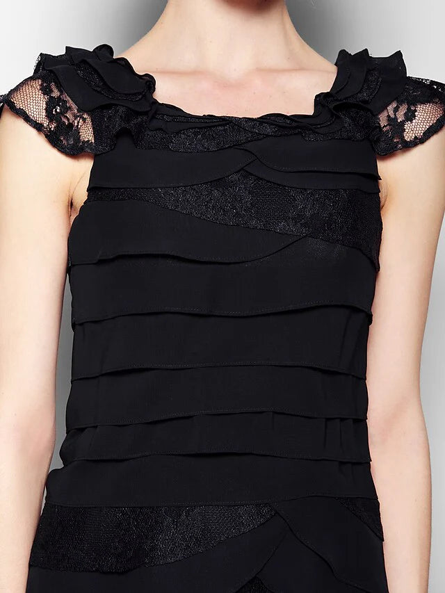 Full length view of a woman wearing the black formal dress.