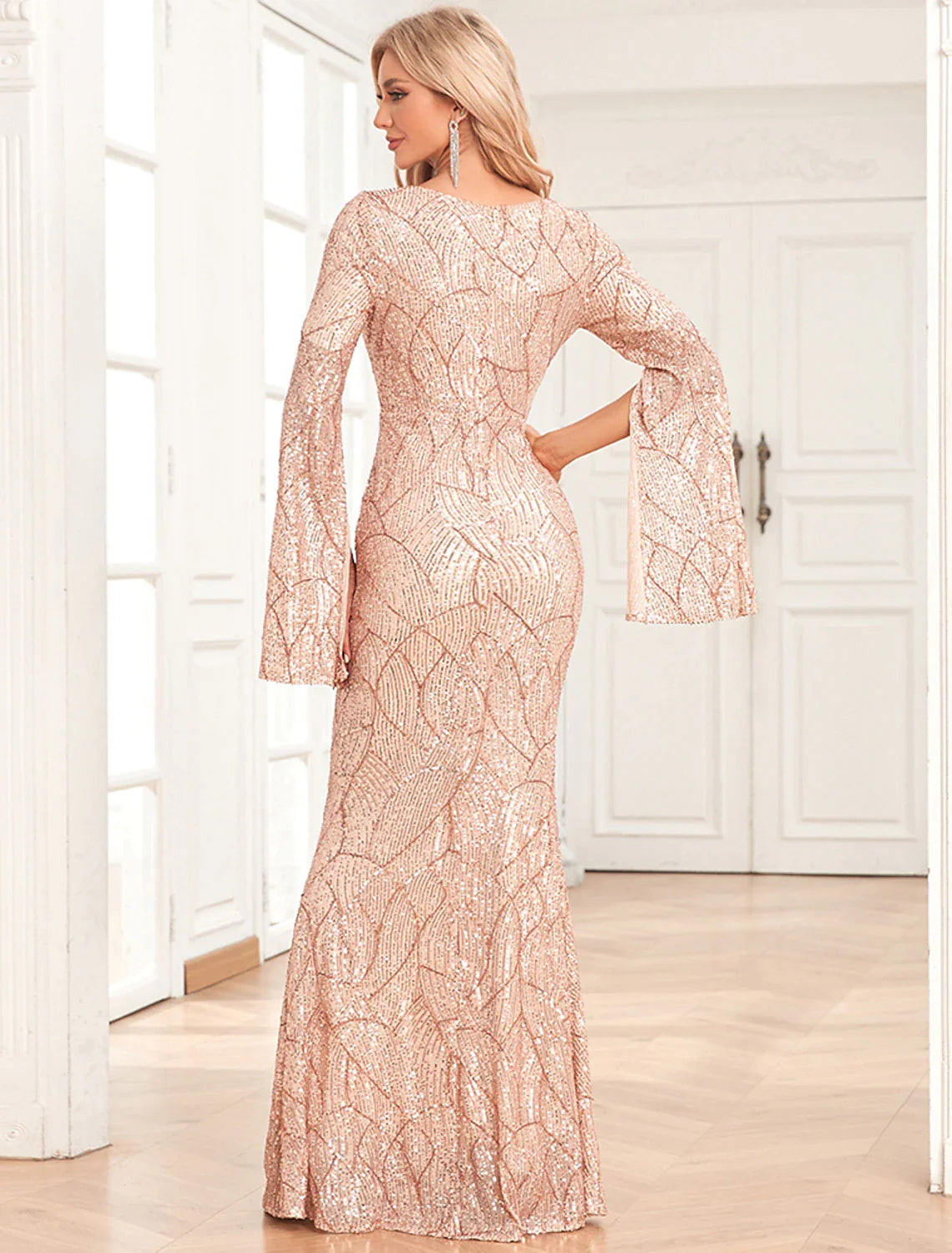 Side view of the sequined mermaid evening gown, highlighting the trumpet silhouette.