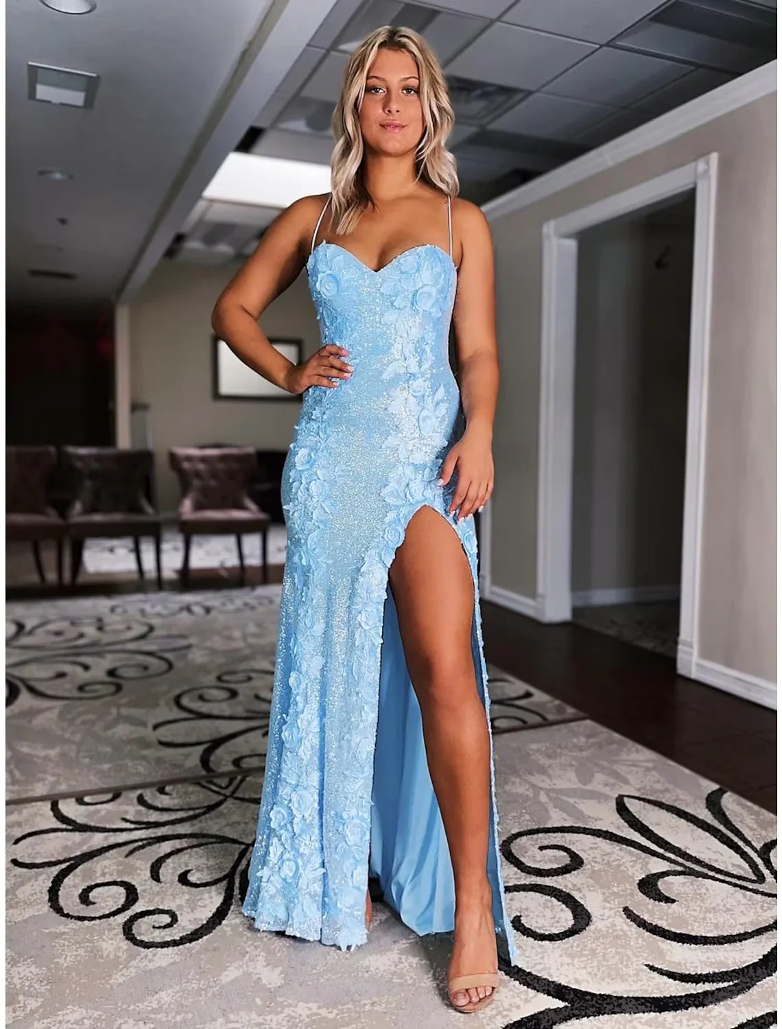 Back view of the elegant mermaid gown, showcasing the backless detail and sweep train.