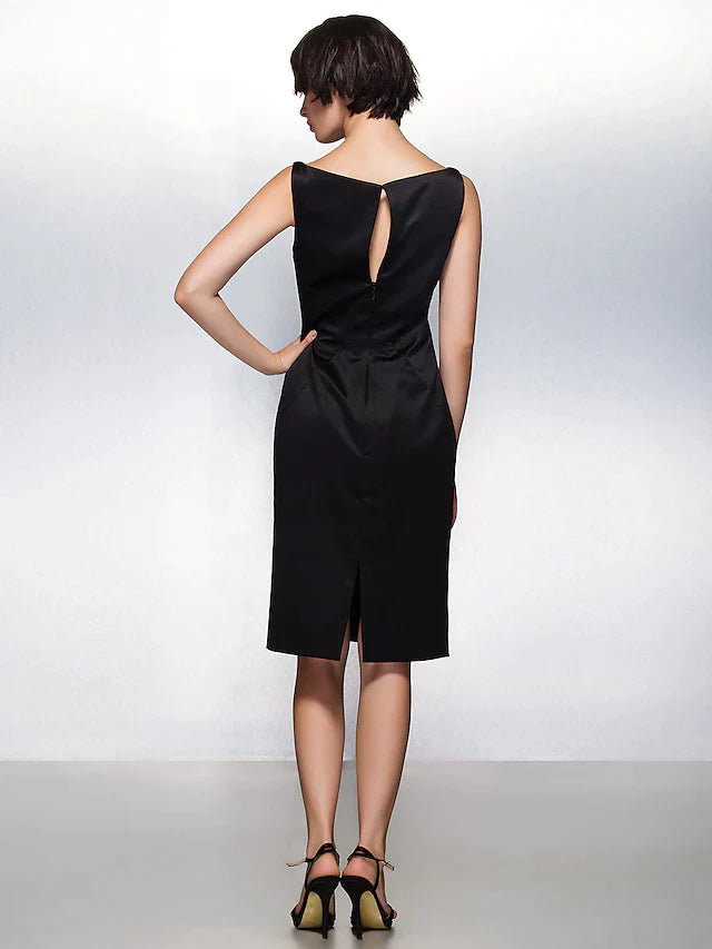Side view of a woman in a dark blue satin sheath dress, highlighting pleats.