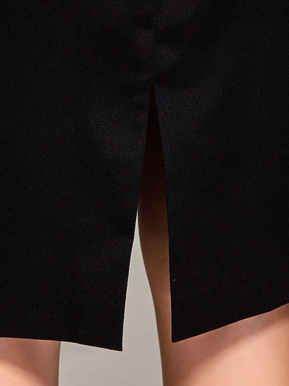 Woman seated, showcasing the drape of a dark blue satin sheath dress.